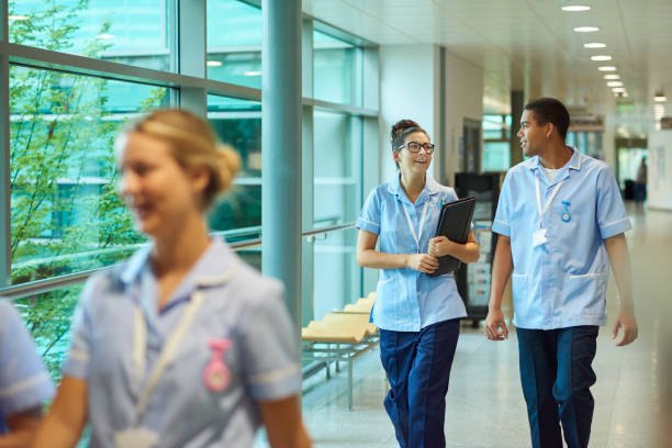 Two colleagues in uniform talking as they walk along a corridor